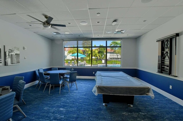 recreation room featuring a paneled ceiling, dark carpet, pool table, and ceiling fan