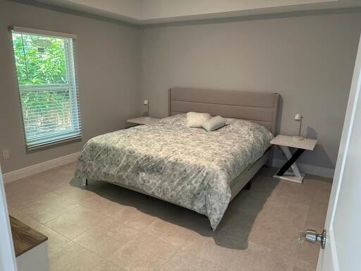 bedroom featuring baseboards