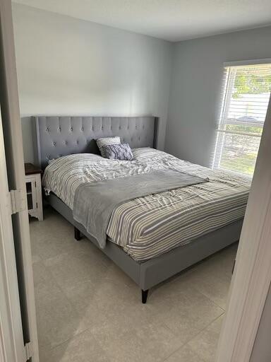 bedroom with light tile patterned flooring