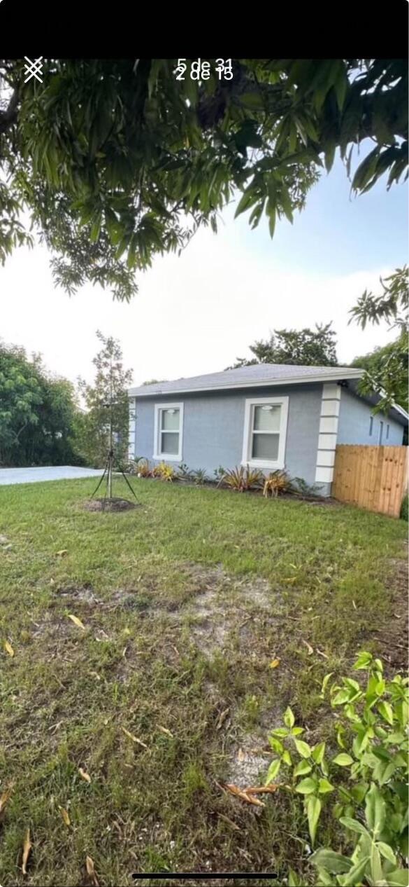 exterior space with a front yard and fence