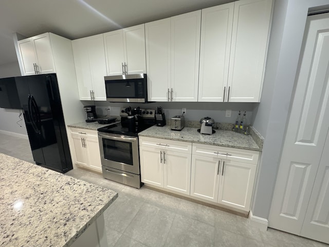 kitchen featuring white cabinets, light stone countertops, and stainless steel appliances