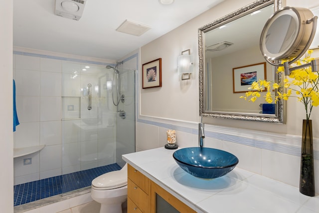 bathroom featuring walk in shower, vanity, tile walls, tile patterned flooring, and toilet