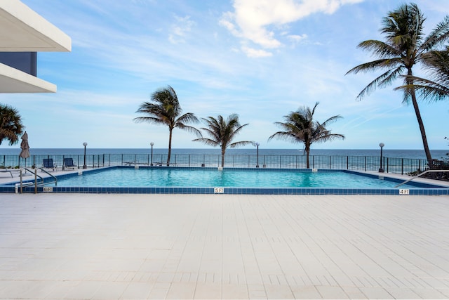 view of pool featuring a water view