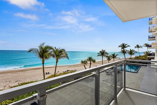 balcony with a view of the beach and a water view