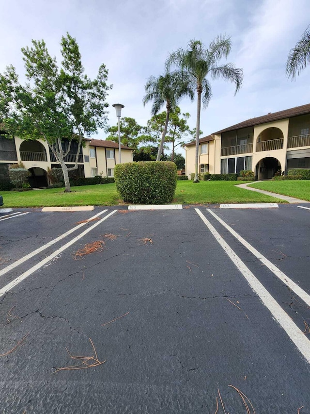 view of car parking featuring a yard