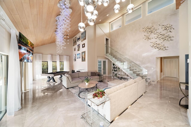 living room with marble finish floor, wooden ceiling, and stairs