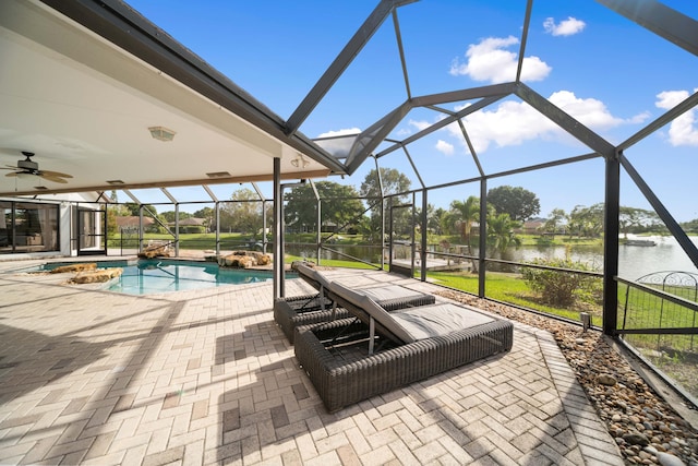 exterior space featuring a lanai and a water view