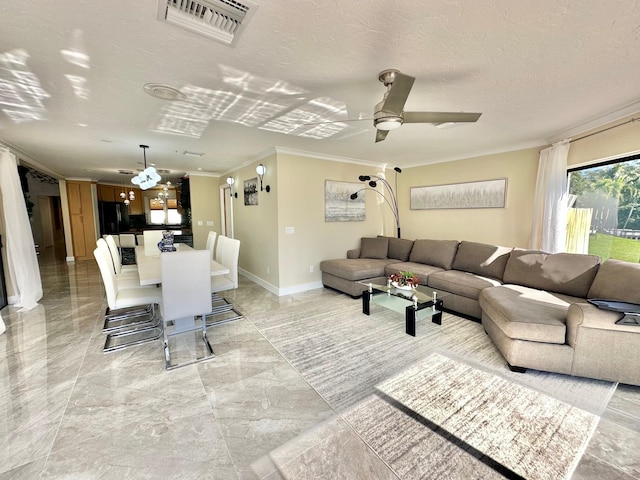 living room with a textured ceiling, ceiling fan, and crown molding