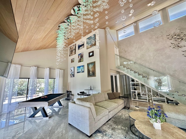 living room featuring wood ceiling, pool table, and a high ceiling