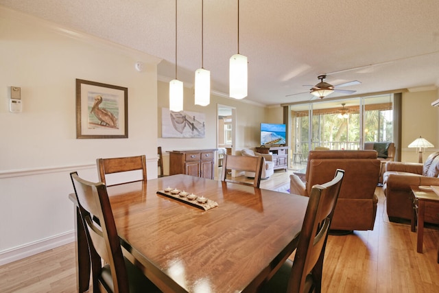 2809 Florida Blvd Unit 208, Delray Beach, FL 33483 - dining space with light wood-style flooring, a textured ceiling, a ceiling fan, and crown molding