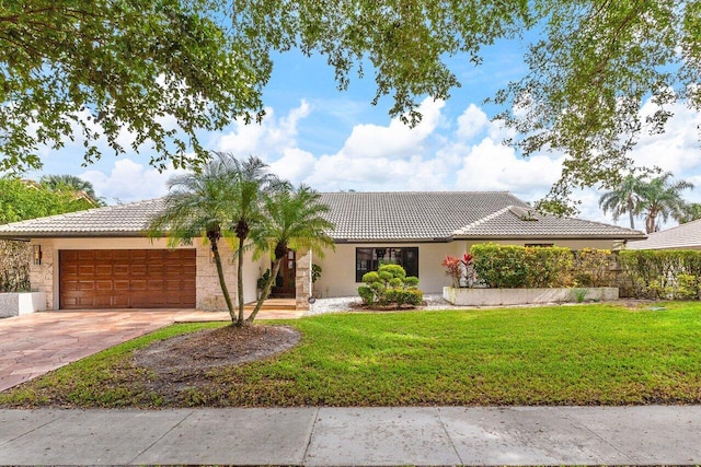 single story home with a front lawn and a garage