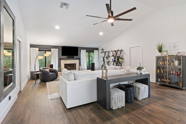 living room featuring dark wood-type flooring, ceiling fan, and high vaulted ceiling