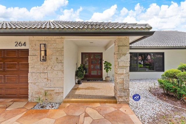 entrance to property with french doors and a garage