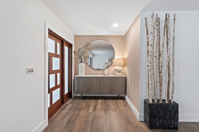 entryway with dark hardwood / wood-style flooring