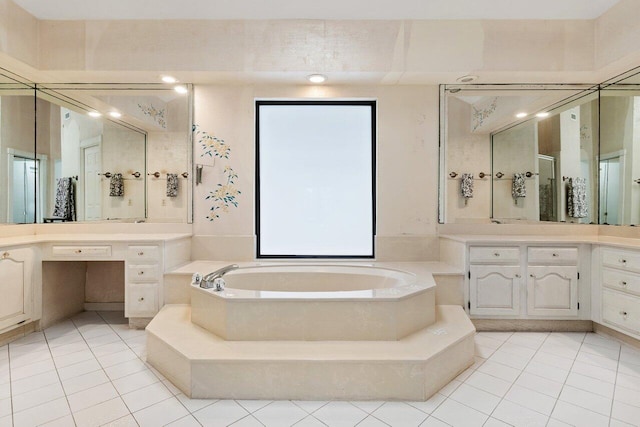 bathroom featuring vanity, tile flooring, and a washtub