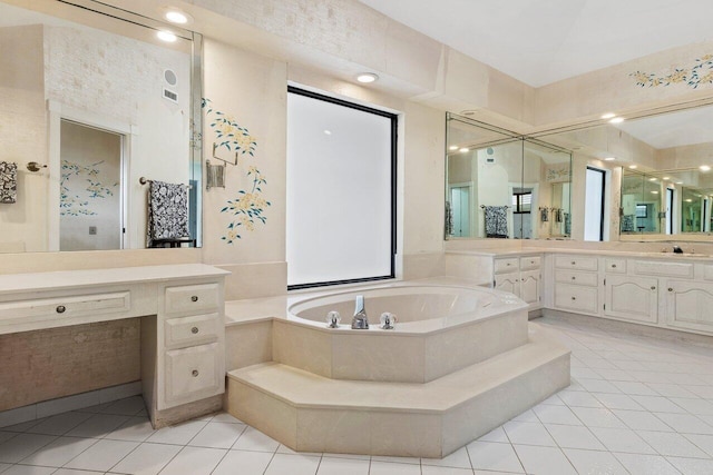 bathroom with vanity, tile flooring, and tiled bath