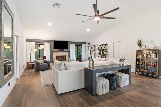 living room featuring high vaulted ceiling, ceiling fan, and dark wood-type flooring