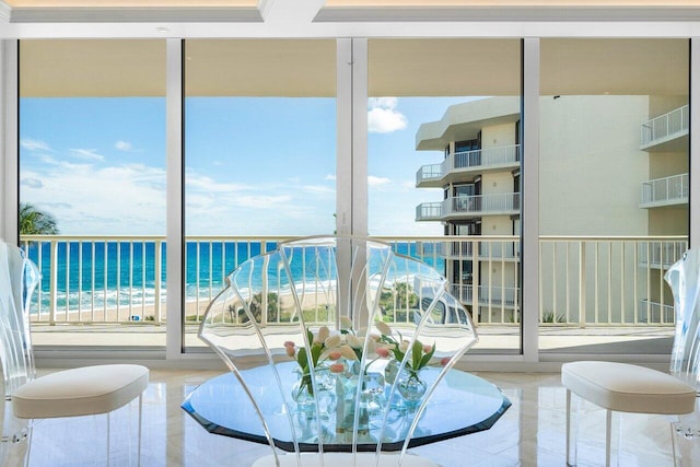 interior space with a water view and a beach view