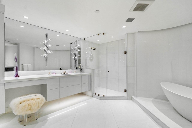 bathroom with tile patterned floors, vanity, and independent shower and bath