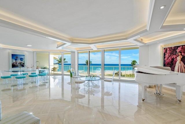 living room featuring a water view and floor to ceiling windows