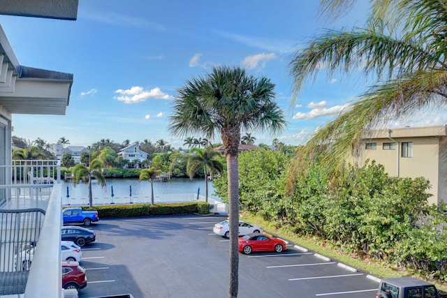 view of parking / parking lot with a water view