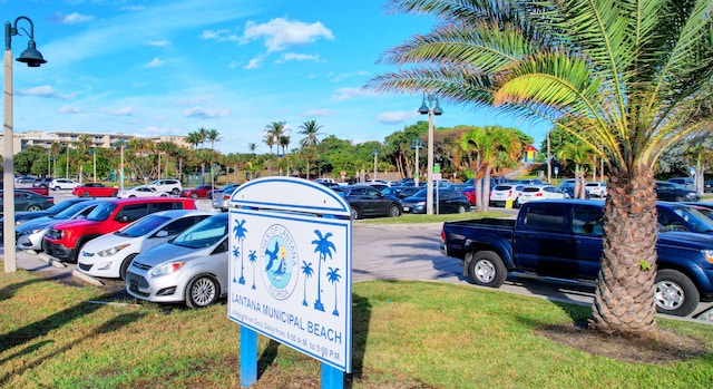 view of vehicle parking with a yard