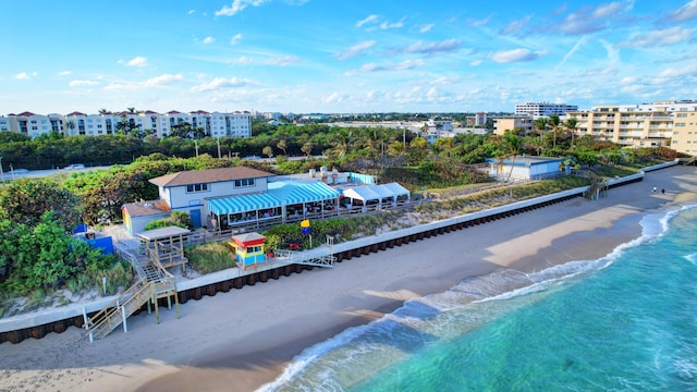 bird's eye view with a water view and a beach view