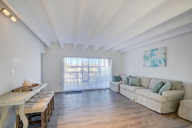 living room featuring beamed ceiling and wood-type flooring