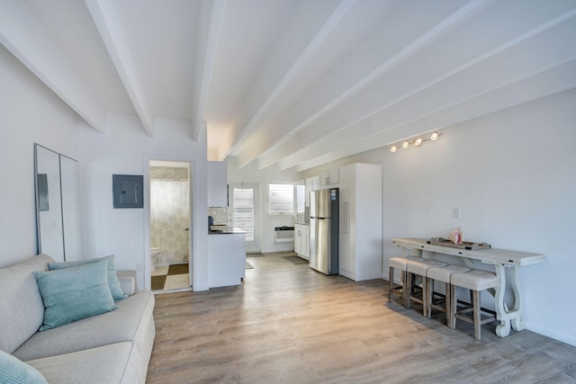 living room with light wood-type flooring, electric panel, and beam ceiling