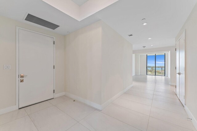 corridor with light tile patterned flooring