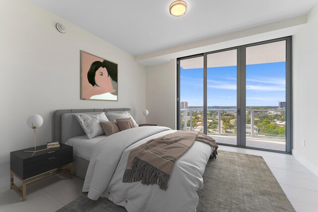 bedroom featuring light tile patterned flooring and access to outside