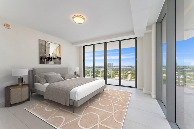 bedroom featuring access to exterior, expansive windows, light tile patterned floors, and multiple windows