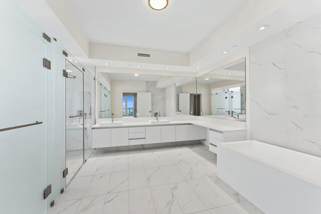 bathroom featuring a shower with shower door, tile patterned flooring, and double vanity