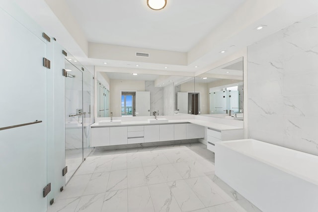 full bath featuring recessed lighting, a sink, marble finish floor, a soaking tub, and a marble finish shower