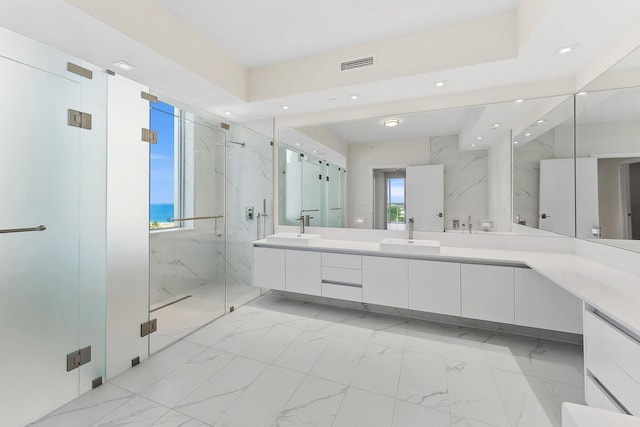 full bath featuring marble finish floor, a marble finish shower, visible vents, and a sink