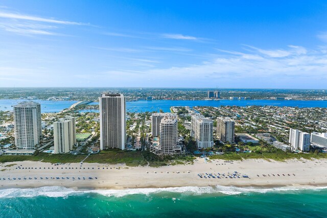 bird's eye view featuring a water view and a beach view