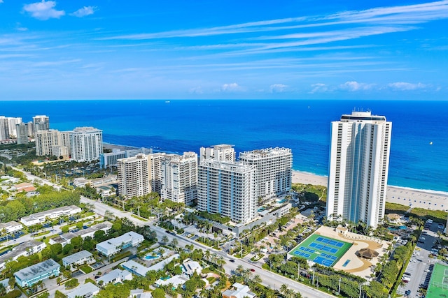 birds eye view of property with a water view, a view of city, and a beach view