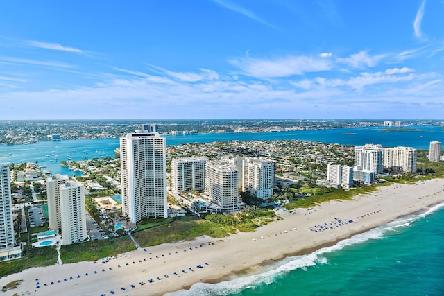 aerial view with a water view, a view of the beach, and a city view