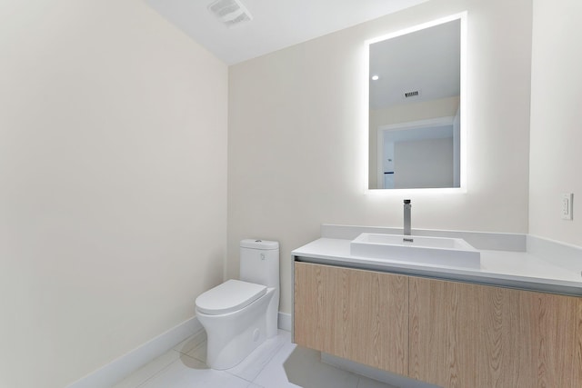 half bath featuring visible vents, toilet, vanity, and tile patterned floors