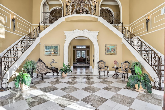 entrance foyer featuring french doors and a towering ceiling