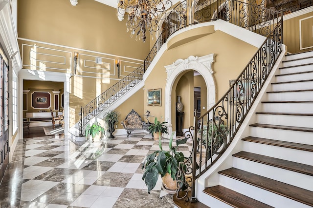 foyer entrance with a notable chandelier and a high ceiling