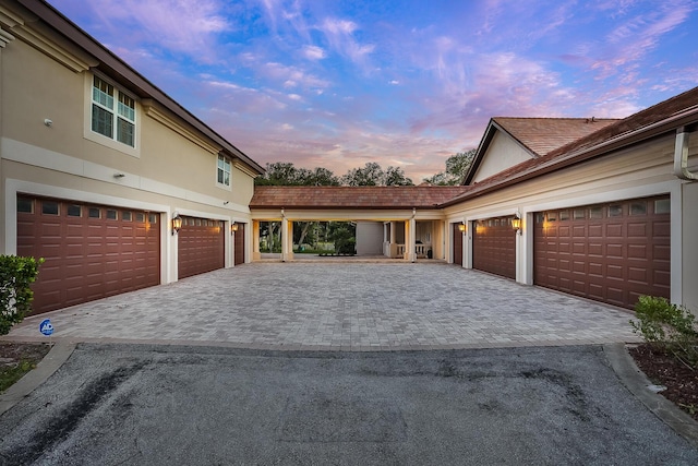 view of garage at dusk