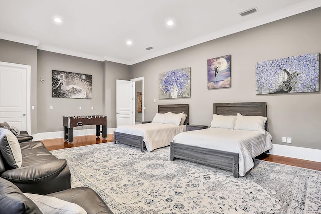 bedroom featuring crown molding and hardwood / wood-style flooring