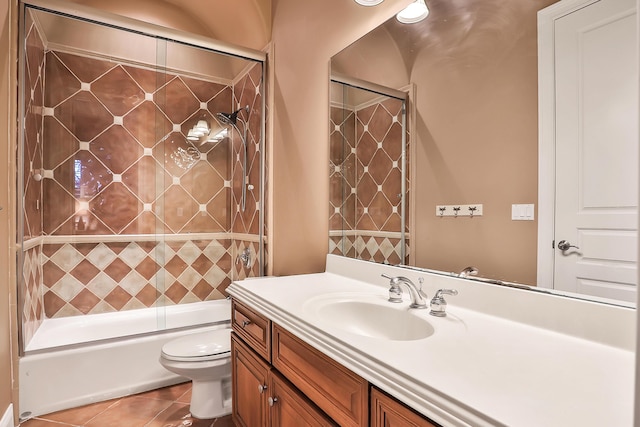 full bathroom with toilet, vanity, tile patterned floors, and enclosed tub / shower combo