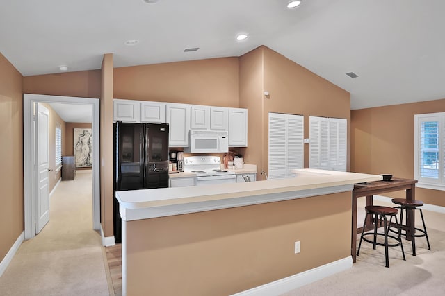 kitchen featuring light carpet, white appliances, vaulted ceiling, white cabinets, and a kitchen island