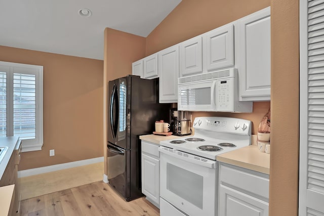 kitchen featuring white cabinets, lofted ceiling, light wood-type flooring, and white appliances