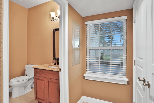 bathroom featuring tile patterned floors, vanity, and toilet