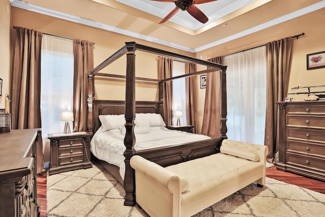 bedroom featuring wood-type flooring, ceiling fan, and crown molding