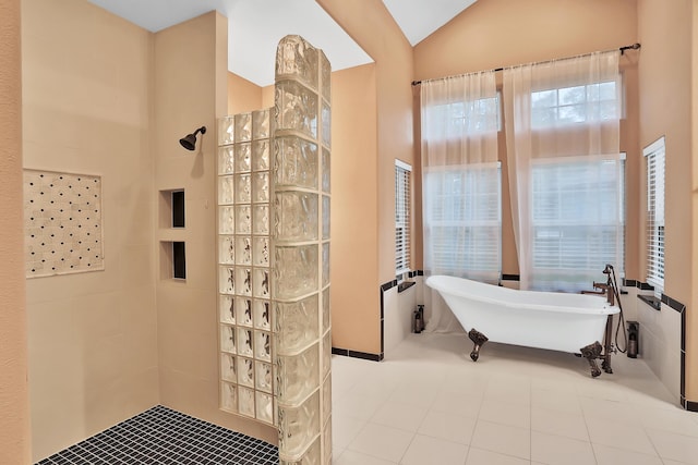 bathroom featuring vaulted ceiling and independent shower and bath