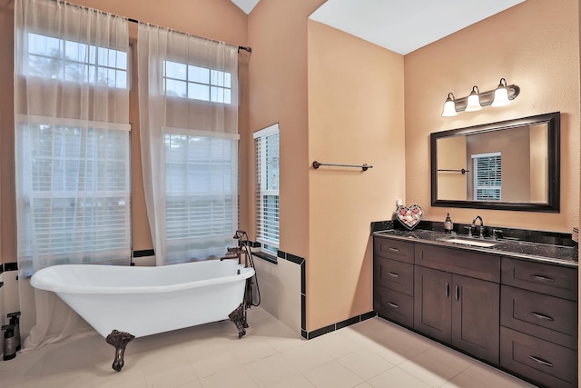 bathroom with a washtub and vanity